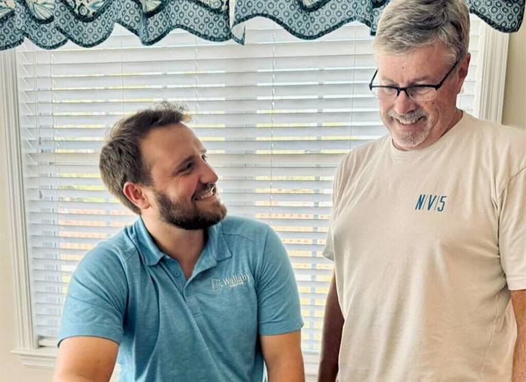 Wallaby Windows team member discussing window replacement options with homeowner during an in-home consultation