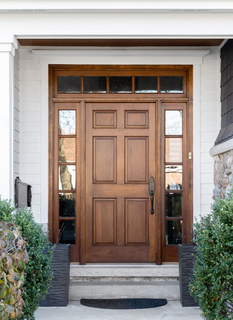 front entry door with decorative sidelights and transom window providing natural light, curb appeal, and energy efficient entryway design