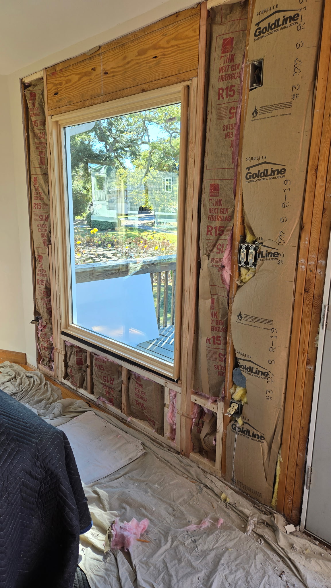Exposed wall showing window replacement framing, insulation, and installation details in Wilmington NC home
