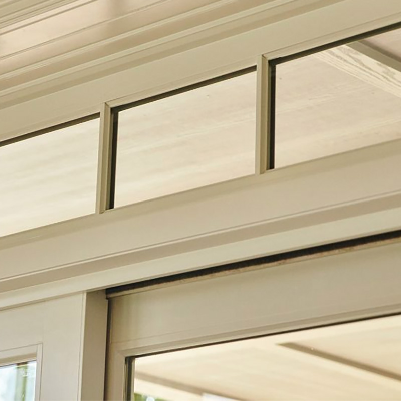 transom window above a sliding door adding natural light and improving airflow as part of a clean professional window installation in coastal Carolina