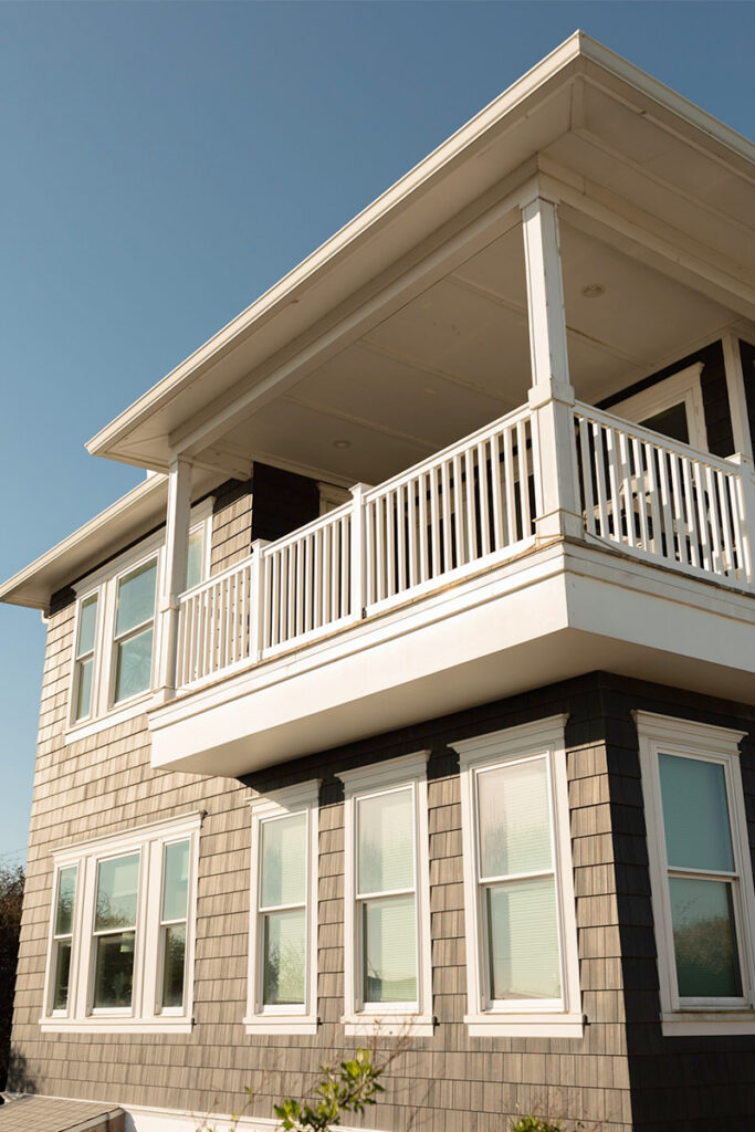Windows That Enhance Curb Appeal coastal home with multiple double hung windows engineered for energy efficiency, salt air resistance, and long-lasting coastal performance