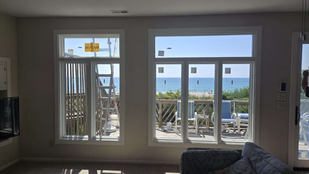 Interior view of newly installed Marvin replacement windows in an oceanfront Emerald Isle home, showcasing energy-efficient glass and coastal views.