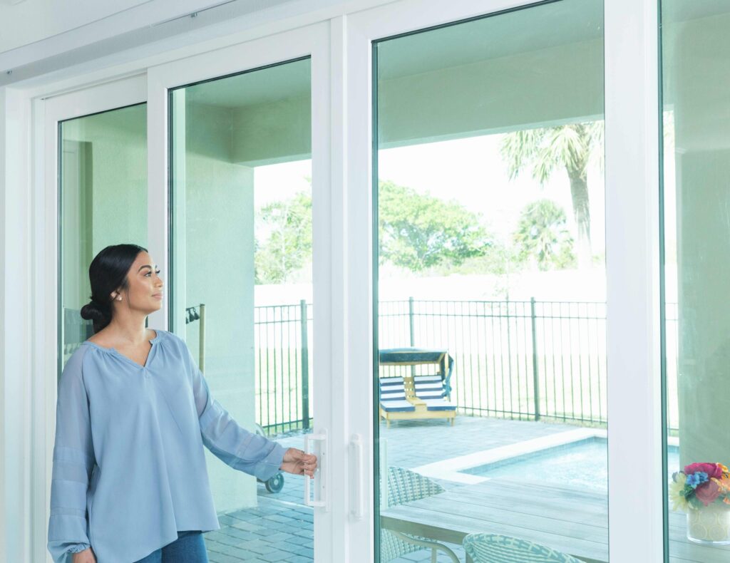 Homeowner opening new sliding glass patio doors installed by Wallaby Windows in Raleigh NC