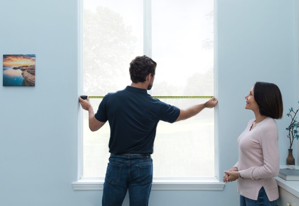 Wallaby Windows professional measuring a window in a Raleigh NC home to understand replacement needs