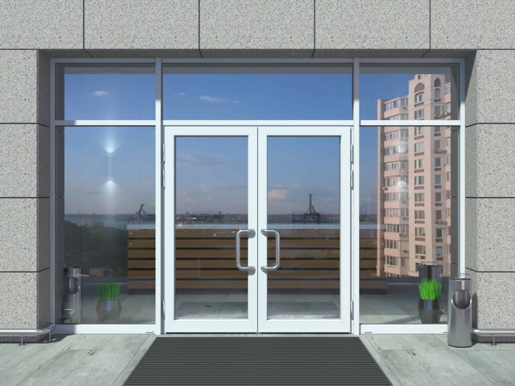 Modern glass double doors with metal handles on commercial building