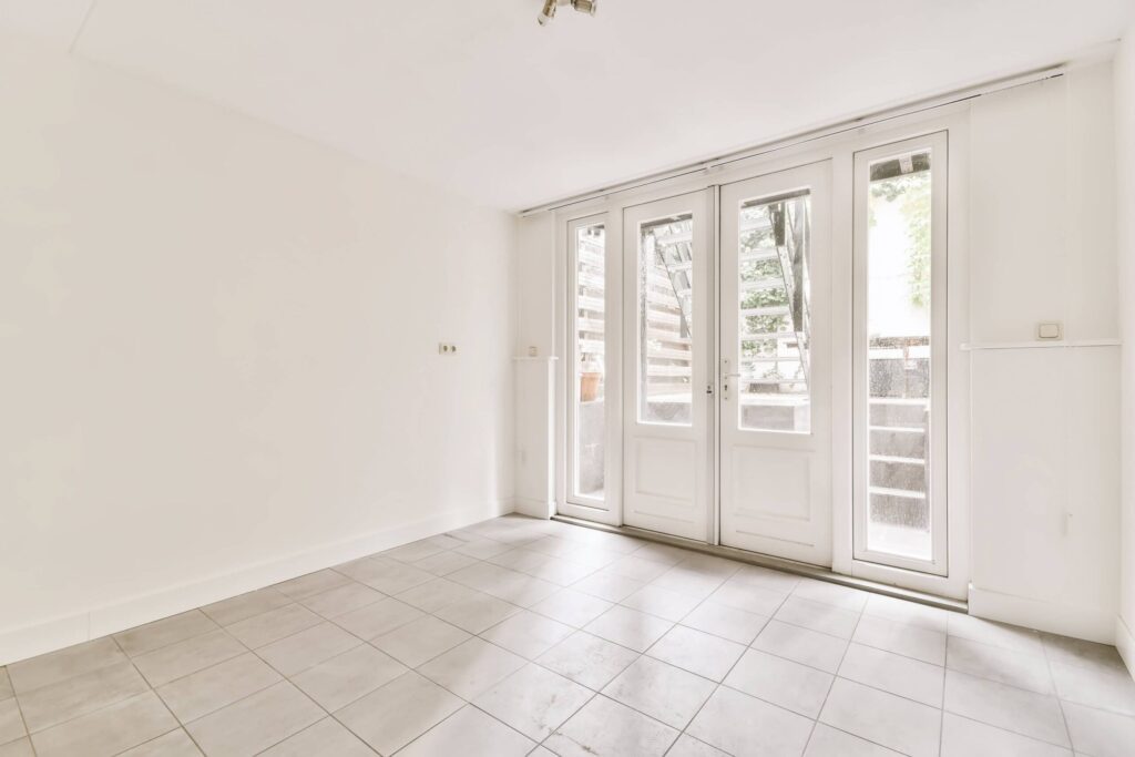White double doors in a modern tiled interior space