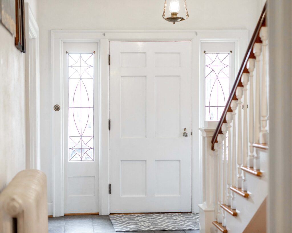 White entry door with decorative side glass panels