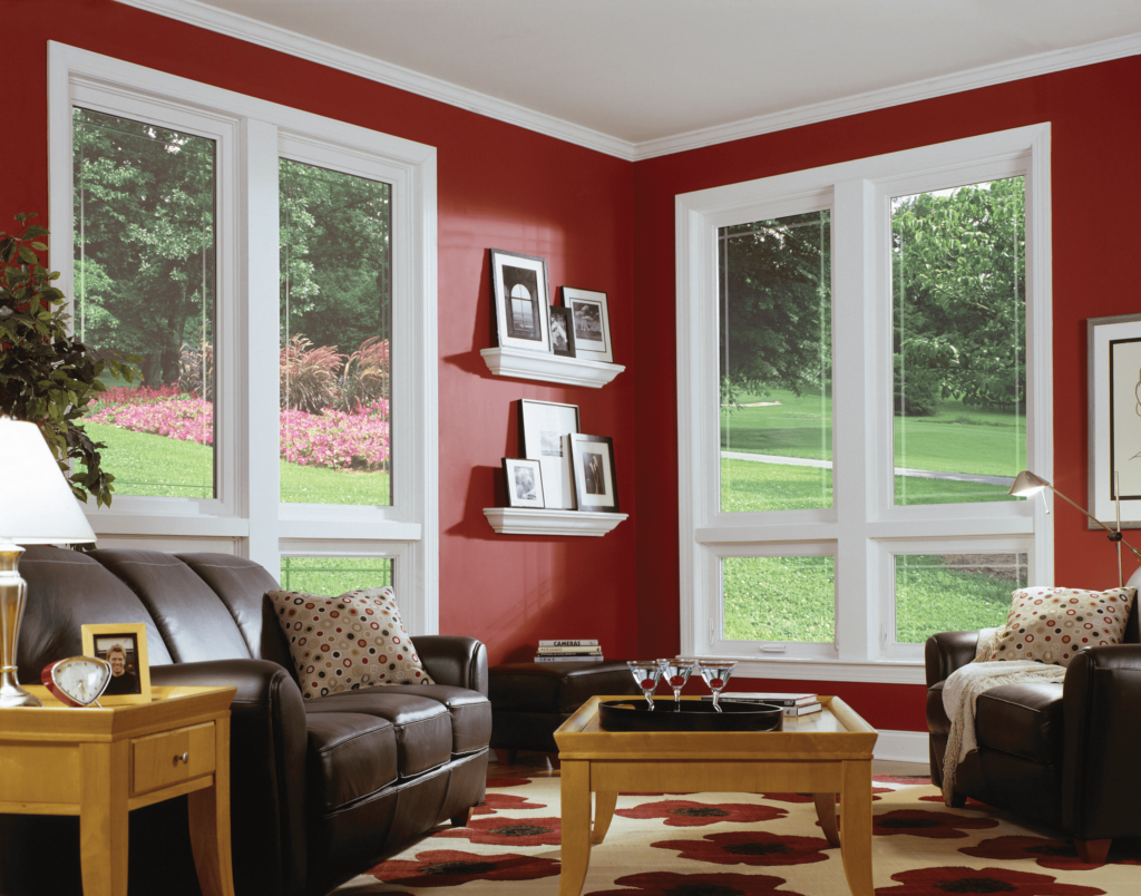 Stylish living room with red walls and awning replacement windows by Wallaby Windows in Fuquay-Varina NC