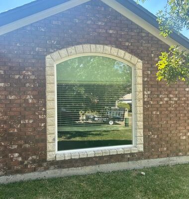 Brick home exterior with new custom geometric windows