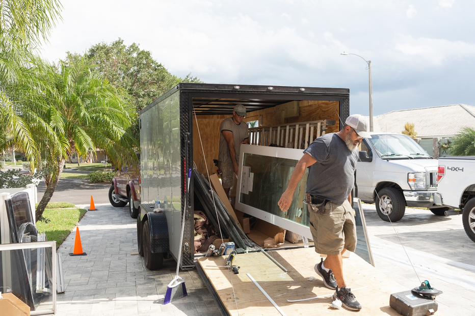 Wallaby Windows installers unloading supplies from trailer to prepare site